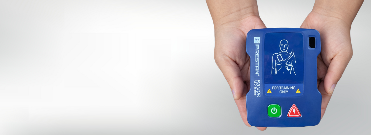 Blue AED (Automated External Defibrillator) device held in a person's hands against a white background